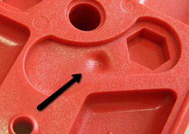 Injection molding sink marks in a plastic insert