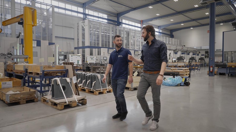 Two men walking in a manufacturing facility factory
